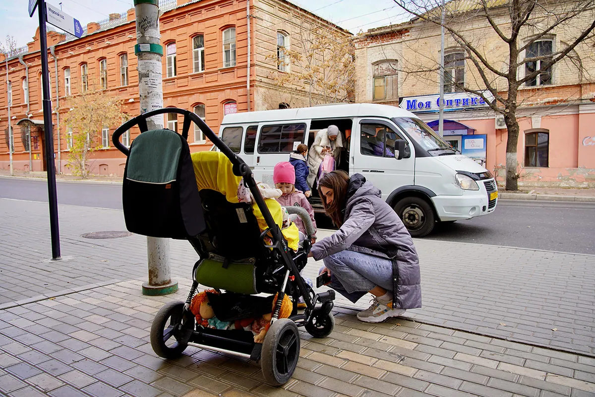 Oksana at the bus stop with children.