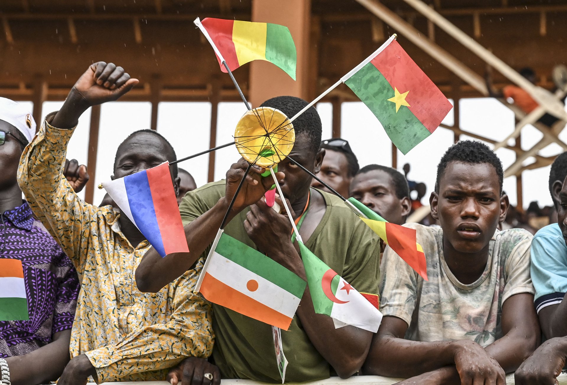Niger’s military junta (which came to power with the help of the Wagner Group) supporter seen with flags of Mali, Burkina Faso, Algeria, Niger, and Russia, August 26, 2023