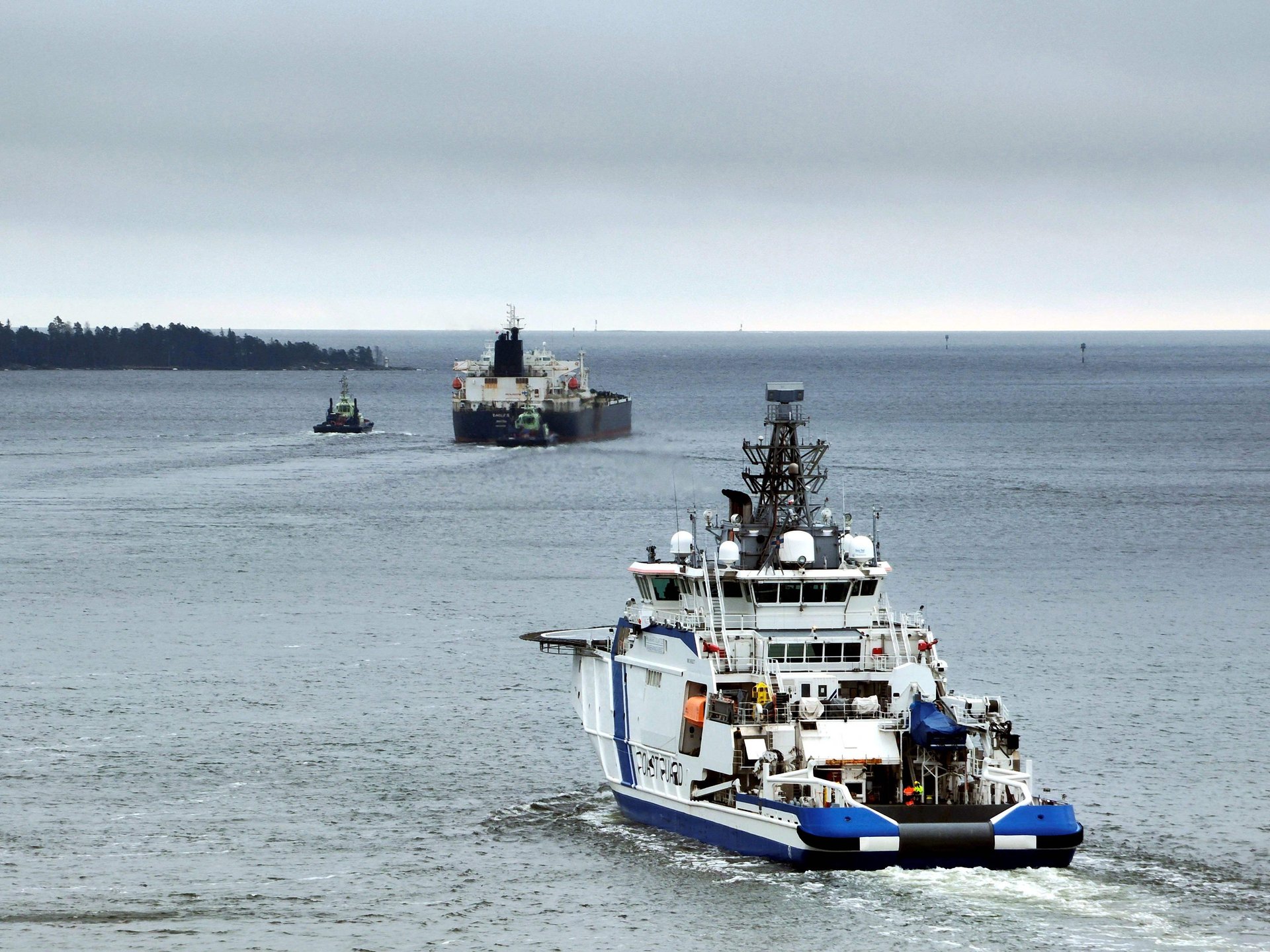 A Finnish border patrol vessel escorting the Eagle S tanker, which had severed five undersea cables in the Baltic Sea, March 2 2025