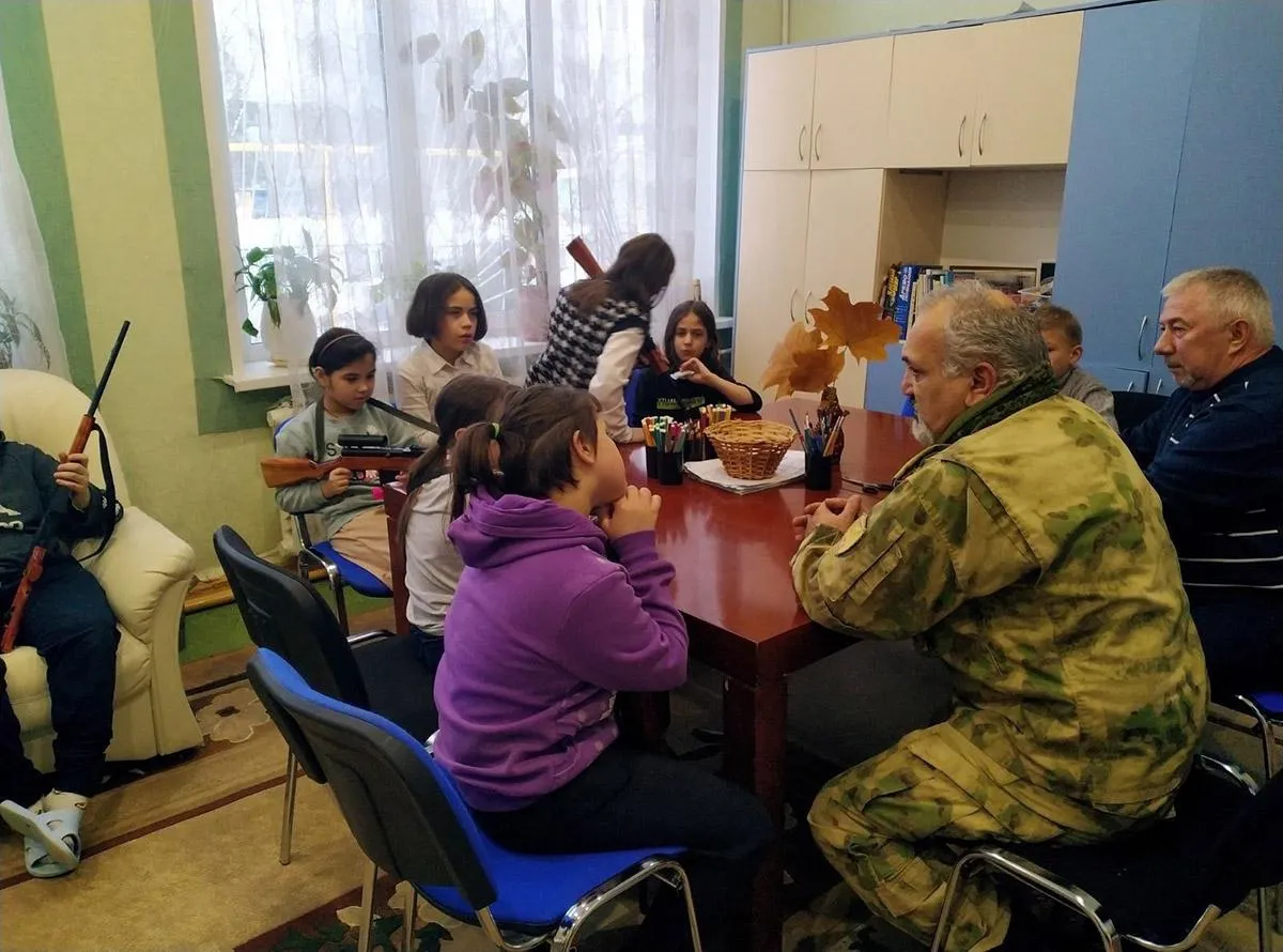 Children from the orphanage at a meeting with the military